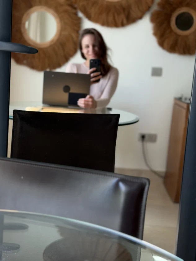 Wearing a cream-coloured top and holding her mobile… guess what happens next? 